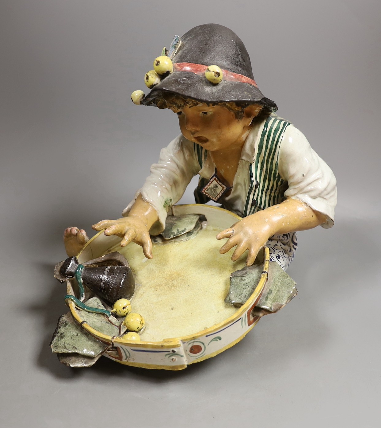 An early 20th century Italian maiolica figure of a boy with tambourine—29 cms high.